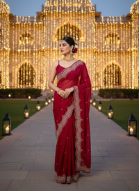 Elegant woman in a vibrant Star Georgette Party Wear Saree featuring heavy golden embroidery and intricate Moti (pearl) work