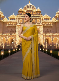 Elegant woman in a vibrant Star Georgette Party Wear Saree featuring heavy golden embroidery and intricate Moti (pearl) work