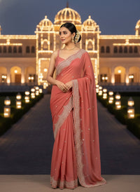 Elegant woman in a vibrant Star Georgette Party Wear Saree featuring heavy golden embroidery and intricate Moti (pearl) work