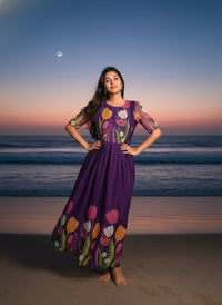 Model in a Midnight Garden purple maxi gown with a vibrant tulip print and delicate ruffle details, perfect for elegant evening events.