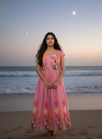 Model in a Midnight Garden purple maxi gown with a vibrant tulip print and delicate ruffle details, perfect for elegant evening events.