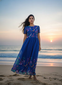 Model in a Midnight Garden purple maxi gown with a vibrant tulip print and delicate ruffle details, perfect for elegant evening events.