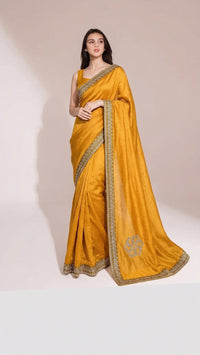 Model wearing a luxurious Soft Shimmer Silk Saree with intricate Swarovski crystal embellishments, diamond work, and elegant lace design details.