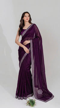 Model wearing a luxurious Soft Shimmer Silk Saree with intricate Swarovski crystal embellishments, diamond work, and elegant lace design details.