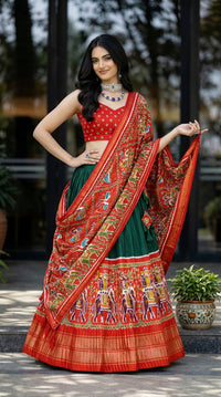 Traditional Patola Paithani Dola Silk Lehenga featuring a vibrant print, intricate foil work, and a delicate Gotta Patti lace border with decorative tassels.