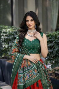 Traditional Patola Paithani Dola Silk Lehenga featuring a vibrant print, intricate foil work, and a delicate Gotta Patti lace border with decorative tassels.