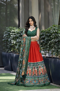 Traditional Patola Paithani Dola Silk Lehenga featuring a vibrant print, intricate foil work, and a delicate Gotta Patti lace border with decorative tassels.