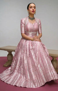Model showcasing a Kanjivaram Zari Weaving Gown Set with a Koti jacket, highlighting intricate gold zari patterns and luxurious fabric, ideal for festive Indian events.