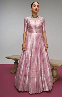 Model showcasing a Kanjivaram Zari Weaving Gown Set with a Koti jacket, highlighting intricate gold zari patterns and luxurious fabric, ideal for festive Indian events.